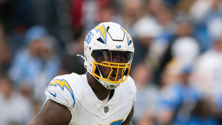 Nov 2, 2025; Nashville, Tennessee, USA;  Los Angeles Chargers linebacker Odafe Oweh (98) celebrates his sack with linebacker Tuli Tuipulotu (45) against the Tennessee Titans during the second half at Nissan Stadium. Mandatory Credit: Steve Roberts-Imagn Images