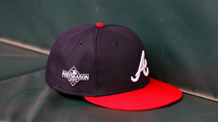 Oct 6, 2023; Atlanta, GA, USA; A detailed view of an Atlanta Braves postseason hat on the bench during a workout before the NLDS against the Philadelphia Phillies at Truist Park. 