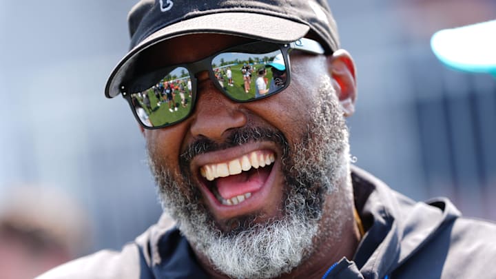 Detroit Lions executive vice president and general manager Brad Holmes laughs with Miami Dolphins coaches 