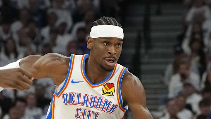 May 26, 2025; Minneapolis, Minnesota, USA; Oklahoma City Thunder guard Shai Gilgeous-Alexander (2) dribbles the ball past Minnesota Timberwolves center Naz Reid (11) in the first half during game four of the western conference finals for the 2025 NBA Playoffs at Target Center. Mandatory Credit: Bruce Kluckhohn-Imagn Images