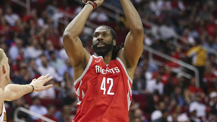 Mar 28, 2019; Houston, TX, USA; Houston Rockets center Nene Hilario (42) shoots the ball over Denver Nuggets forward Mason Plumlee (24) during the second quarter at Toyota Center. Mandatory Credit: Troy Taormina-Imagn Images