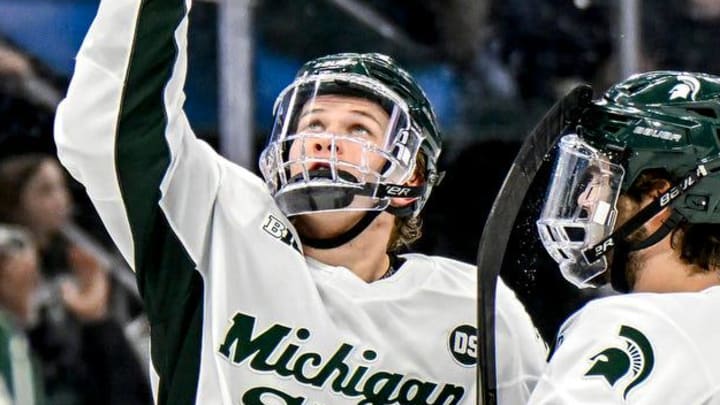 Michigan State's Maxim Strb‡k, center, points to the sky after his goal against Minnesota during the third period on Friday, Jan. 23, 2026, at Munn Ice Arena in East Lansing.