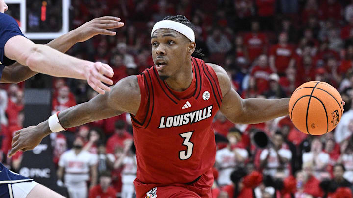 Feb 21, 2026; Louisville, Kentucky, USA;  Louisville Cardinals guard Ryan Conwell (3) dribbles against Georgia Tech Yellow Jackets guard Akai Fleming (0) and center Cole Kirouac (8) during the second half at KFC Yum! Center. Louisville defeated Georgia Tech 87-70. Mandatory Credit: Jamie Rhodes-Imagn Images