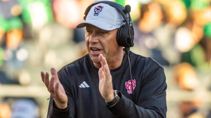 Oct 11, 2025; South Bend, Indiana, USA; NC State Wolfpack head coach Dave Doeren claps as he walks onto the field against the Notre Dame Fighting Irish during the second half at Notre Dame Stadium. Mandatory Credit: Michael Caterina-Imagn Images