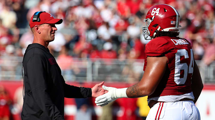 Alabama Crimson Tide head coach Kalen DeBoer high-fives Alabama Crimson Tide offensive lineman Michael Carroll (64)