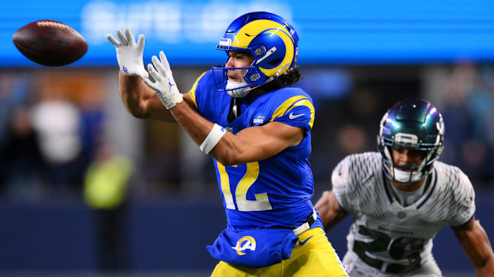 Dec 18, 2025; Seattle, Washington, USA; Los Angeles Rams wide receiver Puka Nacua (12) makes a catch against Seattle Seahawks cornerback Josh Jobe (29) in overtime at Lumen Field. Mandatory Credit: Steven Bisig-Imagn Images
