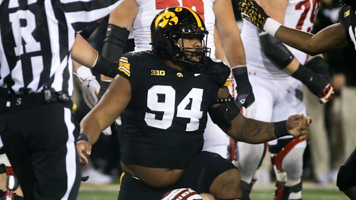 Iowa defensive lineman Yahya Black (94) tackled Wisconsin quarterback Braedyn Locke (18) in the Saturday, Nov. 2, 2024 at Kinnick Stadium in Iowa City, Iowa.