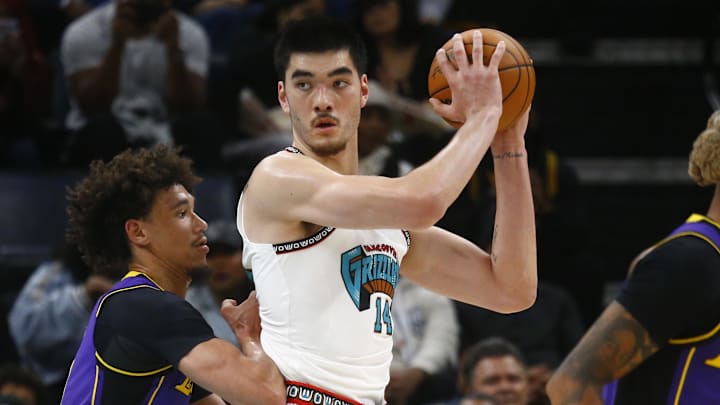 Nov 6, 2024; Memphis, Tennessee, USA; Memphis Grizzlies center Zach Edey (14) handles the ball as Los Angeles Lakers center Jaxson Hayes (11) defends during the first half at FedExForum. Mandatory Credit: Petre Thomas-Imagn Images