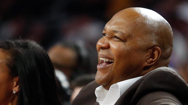Feb 15, 2017; Auburn Hills, MI, USA; Former player Derrick Coleman (right) laughs with his wife Gina Coleman (middle) during the second quarter in the game between the Detroit Pistons and the Dallas Mavericks at The Palace of Auburn Hills. Pistons won 98-91. Mandatory Credit: Raj Mehta-Imagn Images