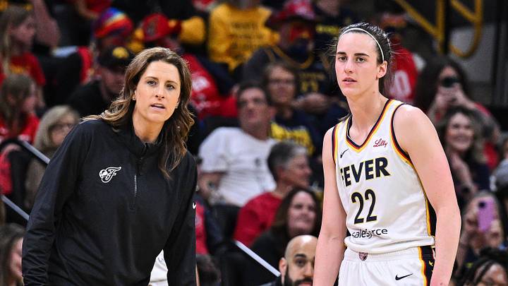 Indiana Fever guard Caitlin Clark (22) looks on with head coach Stephanie White