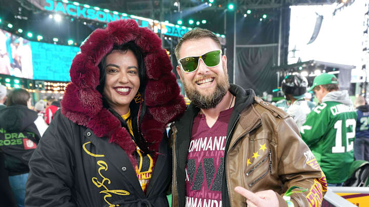 Apr 24, 2025; Green Bay, WI, USA; Washington Commanders female fan Monica Blakely (left) and husband Taylor Blakely pose in Passion for Ezra faux leather legend jackets during the NFL Draft at Lambeau Field. Mandatory Credit: Kirby Lee-Imagn Images Apr 24, 2025; Green Bay, WI, USA; Washington Commanders female fan Monica Blakely (left) and husband Taylor Blakely pose in Passion for Ezra faux leather legend jackets during the NFL Draft at Lambeau Field. Mandatory Credit: Kirby Lee-Imagn Images
