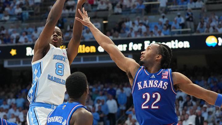 Nov 7, 2025; Chapel Hill, North Carolina, USA; North Carolina Tar Heels forward Caleb Wilson (8) shoots as Kansas Jayhawks forward Flory Bidunga (40) and guard Melvin Council Jr. (14) and guard Darryn Peterson (22) defend in the second half at Dean E. Smith Center. Mandatory Credit: Bob Donnan-Imagn Images Nov 7, 2025; Chapel Hill, North Carolina, USA; North Carolina Tar Heels forward Caleb Wilson (8) shoots as Kansas Jayhawks forward Flory Bidunga (40) and guard Melvin Council Jr. (14) and guard Darryn Peterson (22) defend in the second half at Dean E. Smith Center. Mandatory Credit: Bob Donnan-Imagn Images