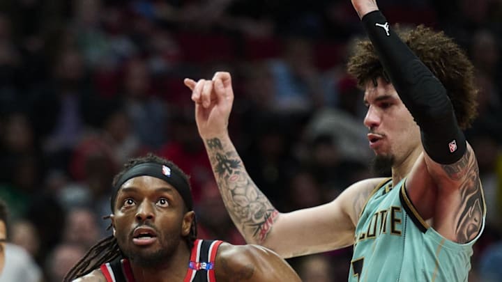 Portland Trail Blazers forward Jerami Grant drives to the basket against Charlotte Hornets guard LaMelo Ball.