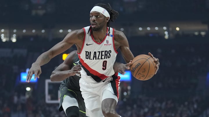 Nov 13, 2024; Portland, Oregon, USA; Portland Trail Blazers small forward Jerami Grant (9) dribbles the ball around Minnesota Timberwolves shooting guard Anthony Edwards (5, left) during the first half at Moda Center. Mandatory Credit: Soobum Im-Imagn Images