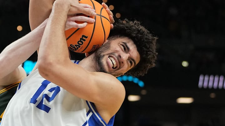 Mar 19, 2026; Greenville, SC, USA; Duke Blue Devils forward Cameron Boozer (12) reacts while getting a rebound against Siena Saints center Riley Mulvey (55) in the second half during a first round game of the men's 2026 NCAA Tournament at Bon Secours Wellness Arena. Mandatory Credit: Bob Donnan-Imagn Images
