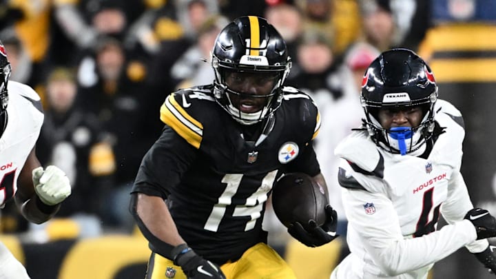 Jan 12, 2026; Pittsburgh, PA, USA; Pittsburgh Steelers running back Kenneth Gainwell (14) runs against Houston Texans defensive end Will Anderson Jr. (51) and cornerback Kamari Lassiter (4) during the second half of an AFC Wild Card Round game at Acrisure Stadium. Mandatory Credit: Barry Reeger-Imagn Images