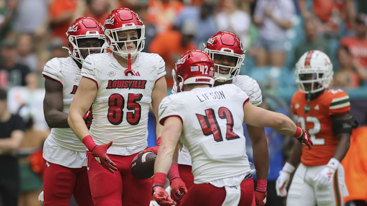 Nov 18, 2023; Miami Gardens, Florida, USA; Louisville Cardinals tight end Nate Kurisky (85) celebrates with tight end Josh Lifson (42) after catching the football against the Miami Hurricanes during the first quarter at Hard Rock Stadium. Mandatory Credit: Sam Navarro-Imagn Images