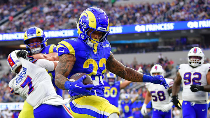 Dec 8, 2024; Inglewood, California, USA; Los Angeles Rams running back Kyren Williams (23) scores a touchdown ahead of Buffalo Bills cornerback Christian Benford (47) during the second half at SoFi Stadium. Mandatory Credit: Gary A. Vasquez-Imagn Images