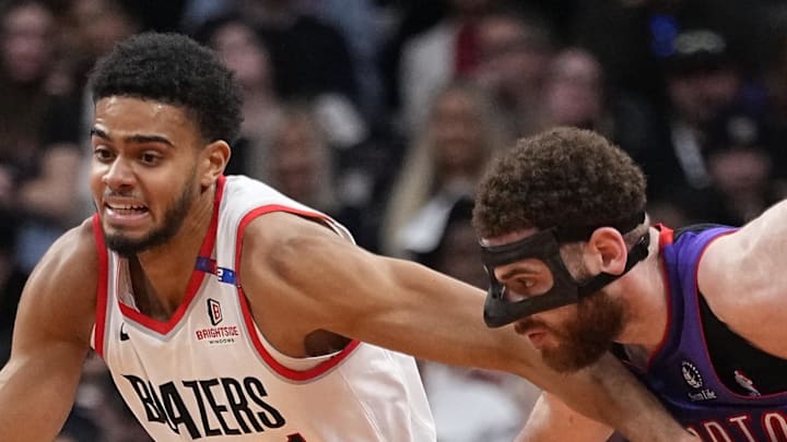 Portland Trail Blazers guard Rayan Rupert fights to get past Toronto Raptors forward Jamison Battle.