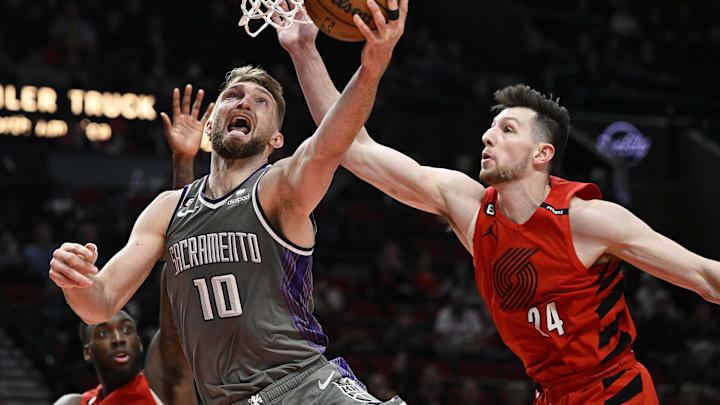 Mar 29, 2023; Portland, Oregon, USA; Sacramento Kings forward Domantas Sabonis (10) scores a basket during the second half against Portland Trail Blazers forward Drew Eubanks (24) at Moda Center. Mandatory Credit: Troy Wayrynen-Imagn Images Mar 29, 2023; Portland, Oregon, USA; Sacramento Kings forward Domantas Sabonis (10) scores a basket during the second half against Portland Trail Blazers forward Drew Eubanks (24) at Moda Center. Mandatory Credit: Troy Wayrynen-Imagn Images