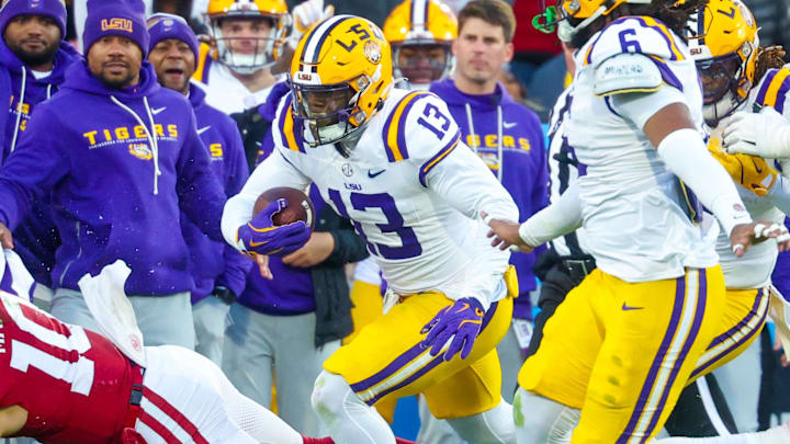 LSU safety A.J. Haulcy intercepts a pass as Oklahoma Sooners quarterback John Mateer tries to make the tackle.