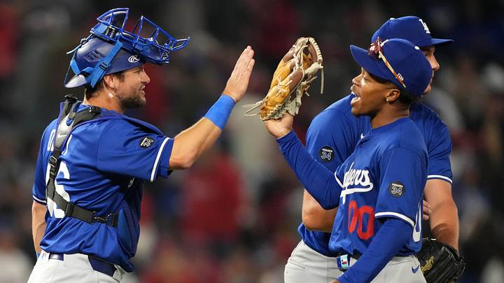 Dodgers catcher Chris Okey (46) and outfielder George Kendall (00) celebrate at the end of the game against the Los Angeles Angels in Anaheim on March 25, 2025.