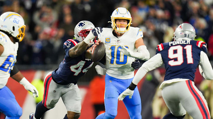 Jan 11, 2026; Foxborough, MA, USA; New England Patriots linebacker K'lavon Chaisson (44) forces a fumble from Los Angeles Chargers quarterback Justin Herbert (10) during the fourth quarter in an AFC Wild Card Round game at Gillette Stadium. Mandatory Credit: David Butler II-Imagn Images