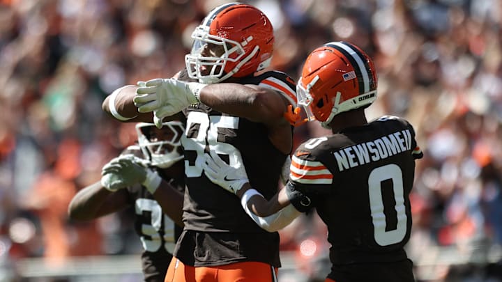 Cleveland Browns defensive end Myles Garrett (95) celebrates with cornerback Greg Newsome II (0) after a play during the second half against the Cincinnati Bengals at Huntington Bank Field.