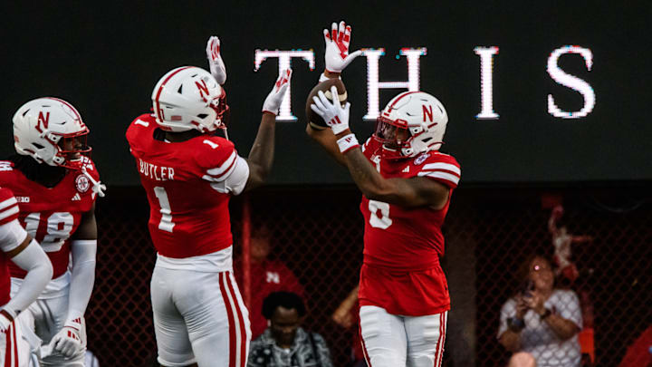 Tommi Hill (right) celebrates his pick-six against Colorado with Jimari Butler.