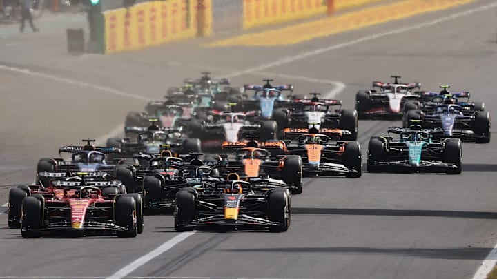Carlos Sainz of Spain driving (55) the Ferrari SF-23 and Max Verstappen of the Netherlands driving the (1) Oracle Red Bull Racing RB19 lead the field into turn one at the start during the F1 Grand Prix of Italy at Autodromo Nazionale Monza on September 03, 2023 in Monza, Italy. 