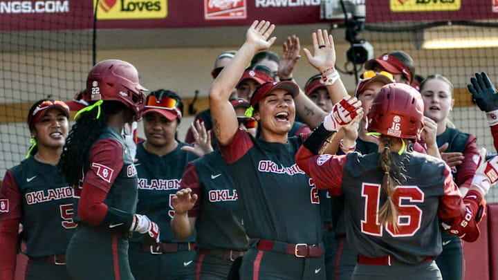 Oklahoma's Abby Dayton returns to the dugout after a game-ending walk against Sam Houston.