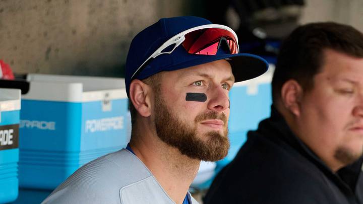 Jun 14, 2026; San Francisco, California, USA; Chicago Cubs infielder Michael Busch (29) uses a massage gun while sitting in the dugout before a game against the San Francisco Giants at Oracle Park. Mandatory Credit: Robert Edwards-Imagn Images