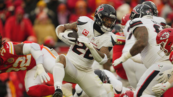 Jan 18, 2025; Kansas City, Missouri, USA; Houston Texans running back Joe Mixon (28) runs the ball against the Kansas City Chiefs during the second quarter of a 2025 AFC divisional round game at GEHA Field at Arrowhead Stadium. Mandatory Credit: Jay Biggerstaff-Imagn Images