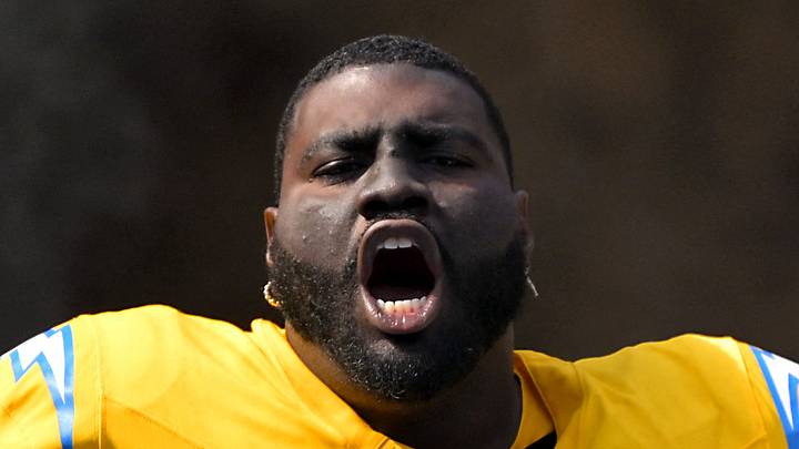 Former  Los Angeles Chargers guard Mekhi Becton runs onto the field