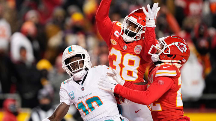 Jan 13, 2024; Kansas City, Missouri, USA; Kansas City Chiefs cornerback L'Jarius Sneed (38) and cornerback Trent McDuffie (22) break up a pass intended for Miami Dolphins wide receiver Tyreek Hill (10) during the second half of the 2024 AFC wild card game at GEHA Field at Arrowhead Stadium. Mandatory Credit: Jay Biggerstaff-Imagn Images