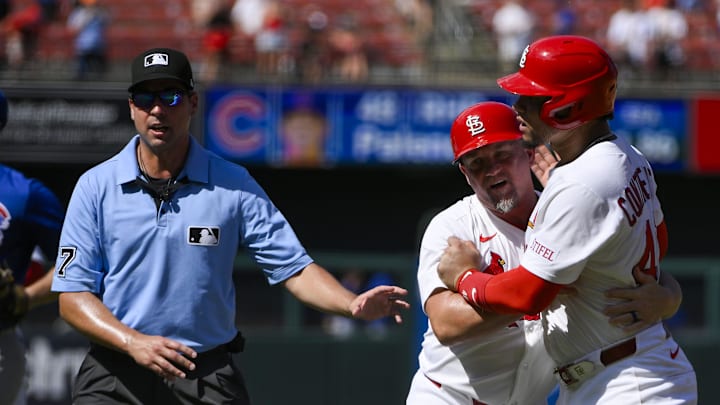 Cardinals first baseman Willson Contreras held back by first base coach Stubby Clapp
