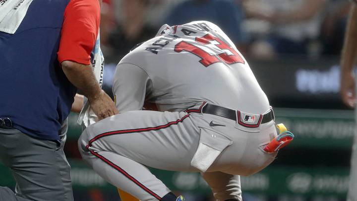 Aug 8, 2023; Pittsburgh, Pennsylvania, USA;  Atlanta Braves right fielder Ronald Acuna Jr. (13) is attended to by a team trainer after being struck by a Pittsburgh Pirates pitch during the sixth inning at PNC Park. Acuna would exit the game. Mandatory Credit: Charles LeClaire-USA TODAY Sports