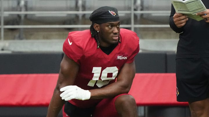 Arizona Cardinals receiver Marvin Harrison Jr. (18) watches from the sidelines during the team's practice at State Farm Stadium on July 29, 2025.