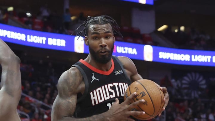 Dec 11, 2024; Houston, Texas, USA; Houston Rockets forward Tari Eason (17) controls the ball as Golden State Warriors forward Draymond Green (23) loses balance during the fourth quarter at Toyota Center. Mandatory Credit: Troy Taormina-Imagn Images