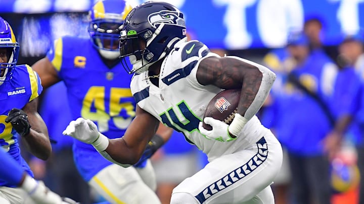 Dec 4, 2022; Inglewood, California, USA; Seattle Seahawks wide receiver DK Metcalf (14) runs the ball against Los Angeles Rams linebacker Ernest Jones (53) during the first half at SoFi Stadium. Mandatory Credit: Gary A. Vasquez-Imagn Images