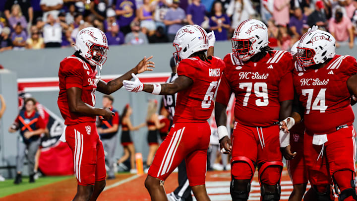 Aug 28, 2025; Raleigh, North Carolina, USA; North Carolina State Wolfpack quarterback CJ Bailey (11) and wide receiver Wesley Grimes (6) celebrate a touchdown against East Carolina Pirates during the first half of the game at Carter-Finley Stadium. Mandatory Credit: Jaylynn Nash-Imagn Images Aug 28, 2025; Raleigh, North Carolina, USA; North Carolina State Wolfpack quarterback CJ Bailey (11) and wide receiver Wesley Grimes (6) celebrate a touchdown against East Carolina Pirates during the first half of the game at Carter-Finley Stadium. Mandatory Credit: Jaylynn Nash-Imagn Images