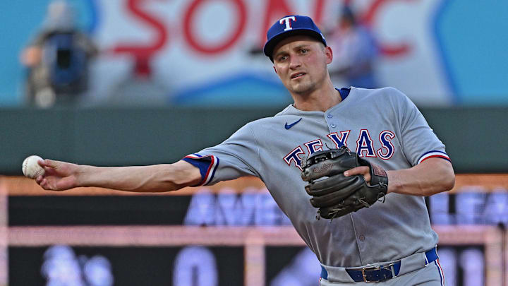 Aug 19, 2025; Kansas City, Missouri, USA;  Texas Rangers shortstop Corey Seager (5) throws to first base in the fourth inning against the Kansas City Royals at Kauffman Stadium. Mandatory Credit: Peter Aiken-Imagn Images