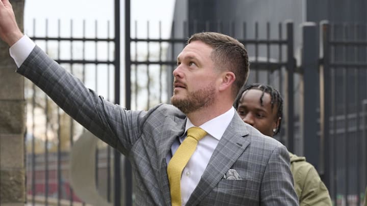 Nov 9, 2024; Eugene, Oregon, USA; Oregon Ducks head coach Dan Lanning touches a metal “O” with players as part of a pre-game custom before a game against the Maryland Terrapins at Autzen Stadium