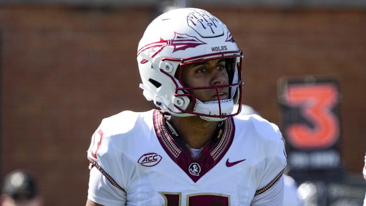 Oct 28, 2023; Winston-Salem, North Carolina, USA; Florida State Seminoles quarterback Jordan Travis (13) and running back Caziah Holmes (26) walk to the sidelines on a timeout during the first half against the Wake Forest Demon Deacons at Allegacy Federal Credit Union Stadium. Mandatory Credit: Jim Dedmon-Imagn Images