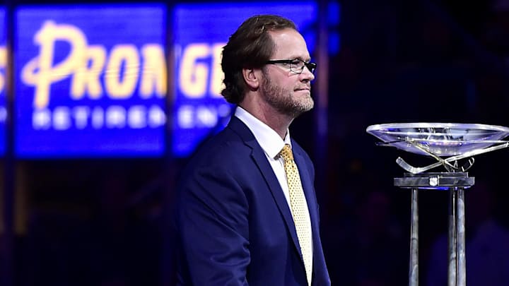 Jan 17, 2022; St. Louis, Missouri, USA;  Former St. Louis Blues defenseman Chris Pronger (44) walks past The Presidents Cup Trophy after his jersey is retired and raised to the rafters prior to a game between the St. Louis Blues and the Nashville Predators at Enterprise Center. Mandatory Credit: Jeff Curry-Imagn Images
