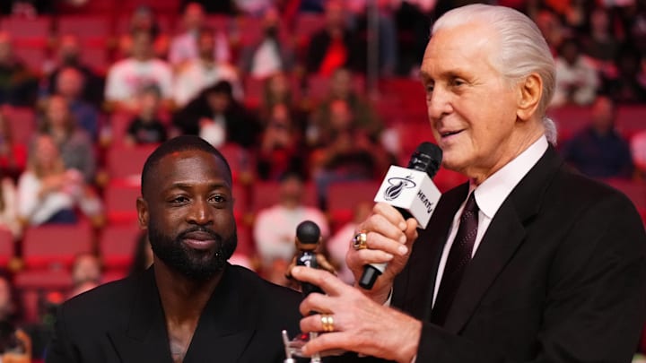 Jan 14, 2024; Miami, Florida, USA; Miami Heat president Pat Riley (R) shows former player Dwayne Wade (L) a bobble head while announcing that a statue in the likeness of Wade will be erected outside the arena in 2025, during halftime of the game between the Miami Heat and the Charlotte Hornets at Kaseya Center. Mandatory Credit: Jasen Vinlove-Imagn Images Jan 14, 2024; Miami, Florida, USA; Miami Heat president Pat Riley (R) shows former player Dwayne Wade (L) a bobble head while announcing that a statue in the likeness of Wade will be erected outside the arena in 2025, during halftime of the game between the Miami Heat and the Charlotte Hornets at Kaseya Center. Mandatory Credit: Jasen Vinlove-Imagn Images