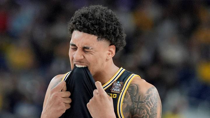 Michigan forward Yaxel Lendeborg (23) bites his jersey following a play in the first half of their Final Four game against Arizona at Lucas Oil Stadium in Indianapolis on Saturday, April 4, 2026.