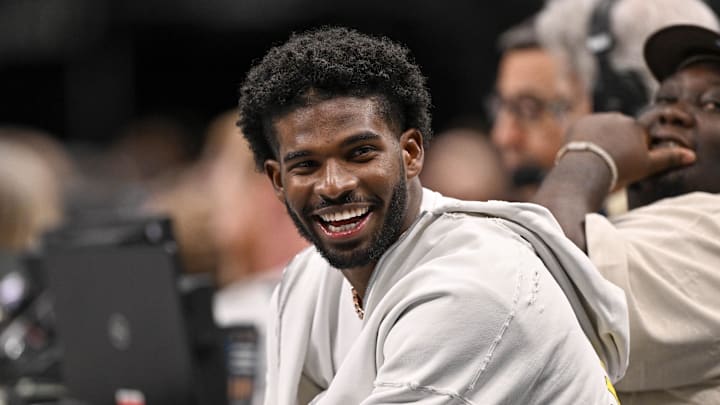 Jan 14, 2025; Dallas, Texas, USA; Colorado Buffaloes quarterback Shedeur Sanders laughs as he watches the game between the Dallas Mavericks and the Denver Nuggets during the second half at the American Airlines Center. Mandatory Credit: Jerome Miron-Imagn Images Jan 14, 2025; Dallas, Texas, USA; Colorado Buffaloes quarterback Shedeur Sanders laughs as he watches the game between the Dallas Mavericks and the Denver Nuggets during the second half at the American Airlines Center. Mandatory Credit: Jerome Miron-Imagn Images