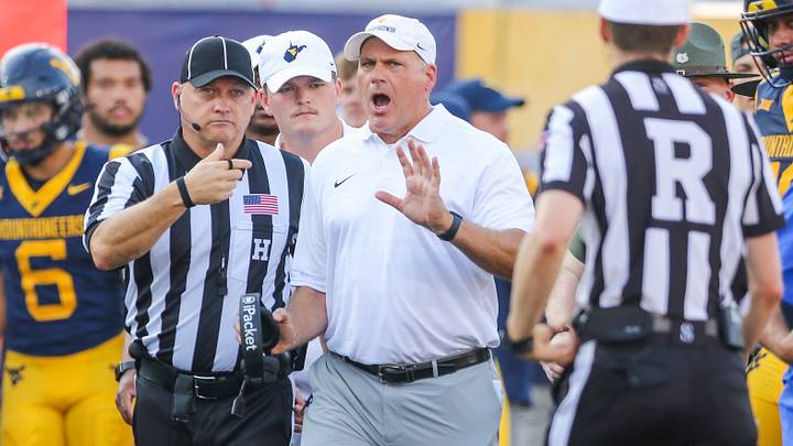 Sep 13, 2025; Morgantown, West Virginia, USA; West Virginia Mountaineers head coach Rich Rodriguez yells at the referee during the second quarter against the Pittsburgh Panthers at Milan Puskar Stadium. Mandatory Credit: Ben Queen-Imagn Images