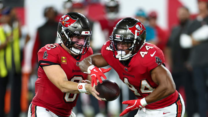 Oct 21, 2024; Tampa, Florida, USA; Tampa Bay Buccaneers quarterback Baker Mayfield (6) hands off to running back Sean Tucker (44) against the Baltimore Ravens in the second quarter at Raymond James Stadium. Mandatory Credit: Nathan Ray Seebeck-Imagn Images